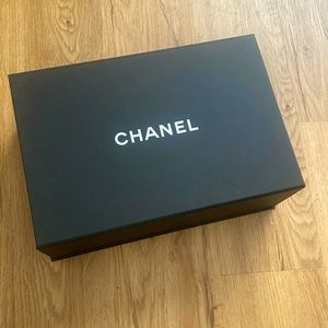 Empty Chanel box with Chanel tissue paper and ribbon